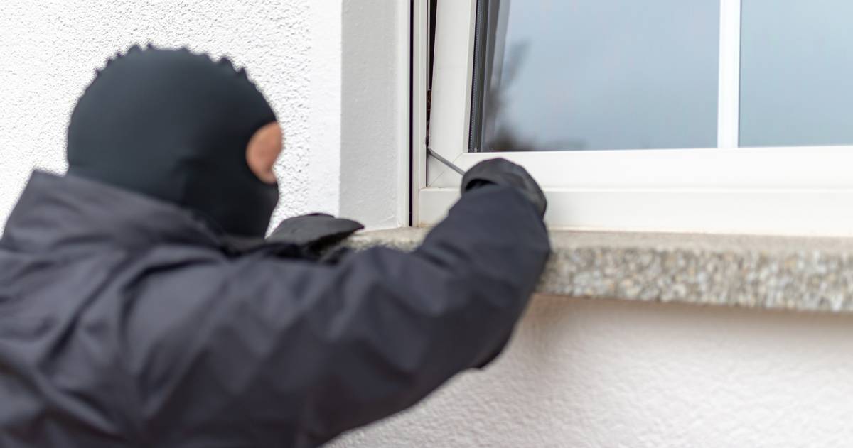 Man met bivakmuts op probeert met een schroevendraaier in te breken via een raam